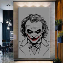 Load image into Gallery viewer, Rolled tube packaging for canvas prints laid on a wooden surface with pink decorative leaves.