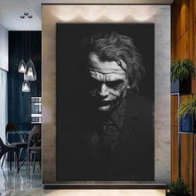 Load image into Gallery viewer, Rolled tube packaging for canvas prints laid on a wooden surface with pink decorative leaves.