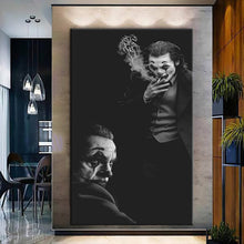 Load image into Gallery viewer, Rolled tube packaging for canvas prints laid on a wooden surface with pink decorative leaves.