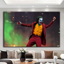 Load image into Gallery viewer, Canvas printed painting of the Joker, featuring bold colors and sharp details in a modern living space.